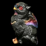 Sitting Griffin Chick Sculpture in Black Sunset