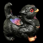 Crouching Griffin Chick Sculpture in Black Sunset